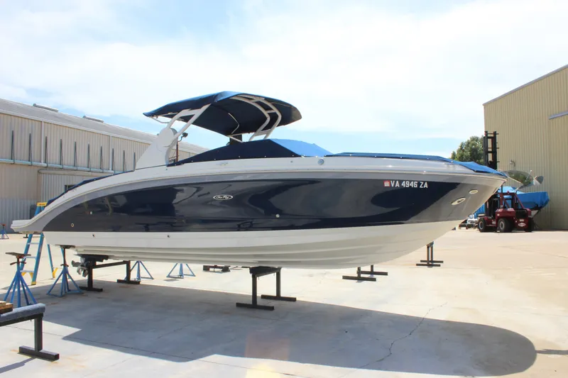 Slide: The Image of 2019 Sea Ray SDX 290 boat on stands in a marina setting. - 8