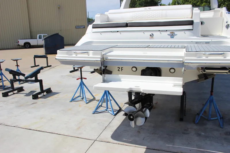 Slide: The Image of 2019 Sea Ray SDX 290 boat on stands, showcasing rear view and propeller. - 15
