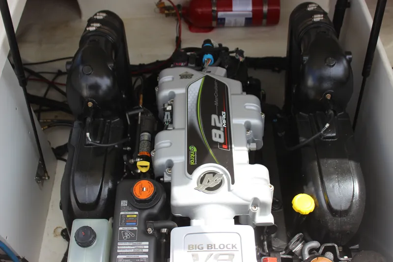 Slide: The Image of Engine compartment of a 2019 Sea Ray SDX 290 boat featuring a MerCruiser 8.2 MAG engine. - 52