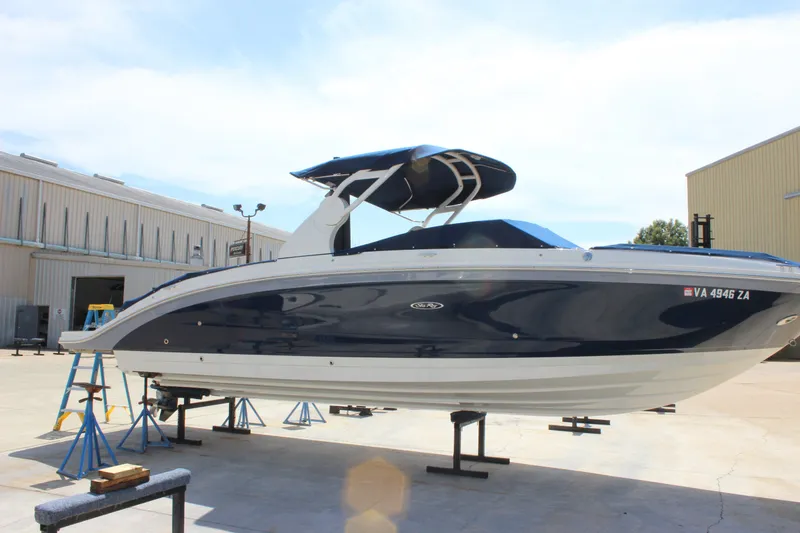 Slide: The Image of 2019 Sea Ray SDX 290 boat on stands outside a warehouse. - 7