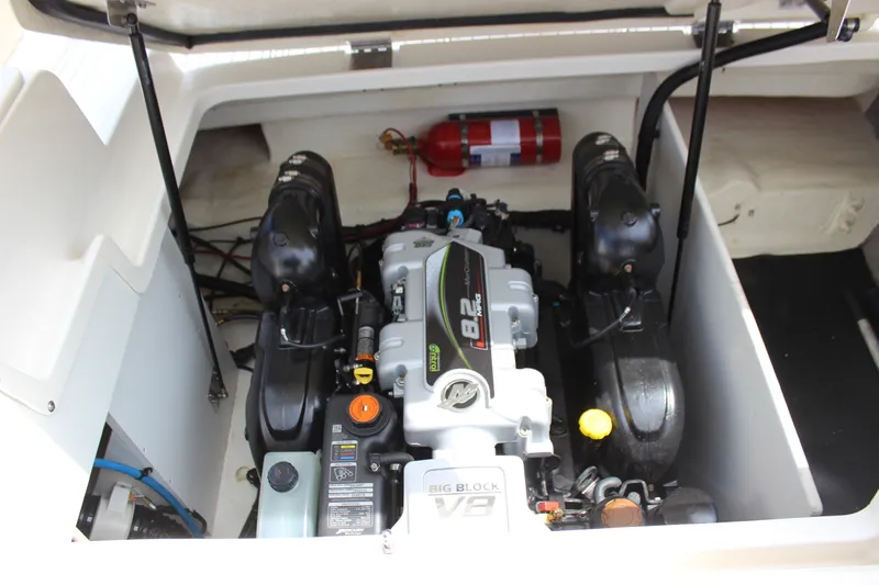 Slide: The Image of Engine compartment of a 2019 Sea Ray SDX 290 boat, featuring a powerful V8 engine. - 54
