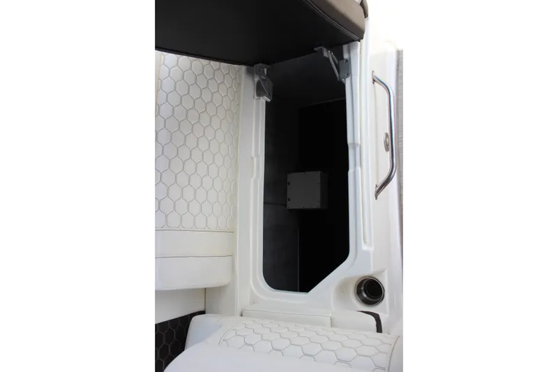 Slide: The Image of 2019 Sea Ray SDX 290 interior storage compartment with hexagonal pattern upholstery. - 44