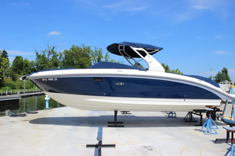 The Image of 2019 Sea Ray SDX 290 boat on dry dock, blue hull, sunny day. - 0