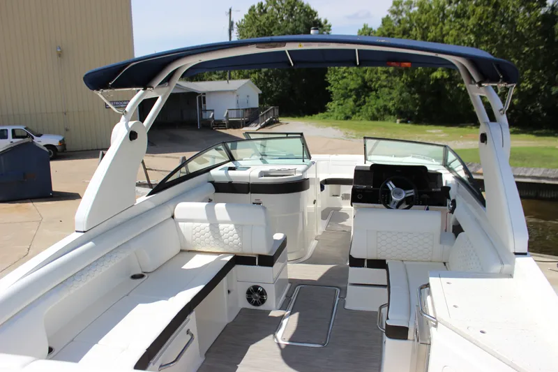 Slide: The Image of 2019 Sea Ray SDX 290 boat interior with white seating and modern dashboard. - 32