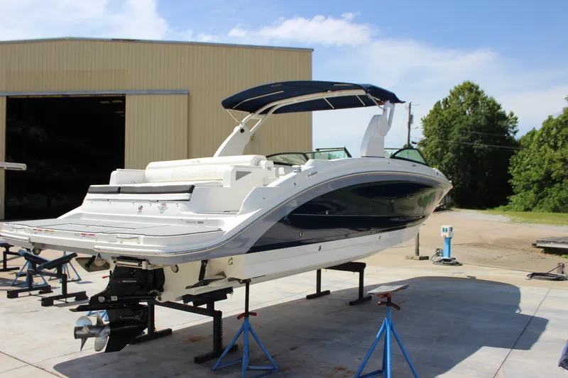 Slide: The Image of 2019 Sea Ray SDX 290 boat on stands, outdoor setting, sunny day. - 22