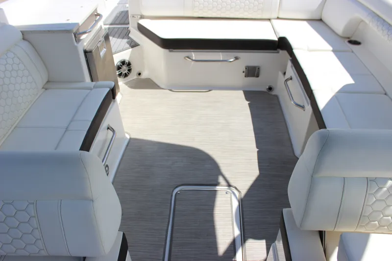 Slide: The Image of 2019 Sea Ray SDX 290 boat interior with white seating and modern design. - 43