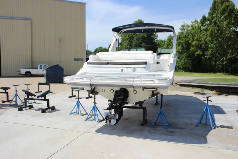 Slide: The Image of 2019 Sea Ray SDX 290 boat on stands, outdoor storage area. - 21