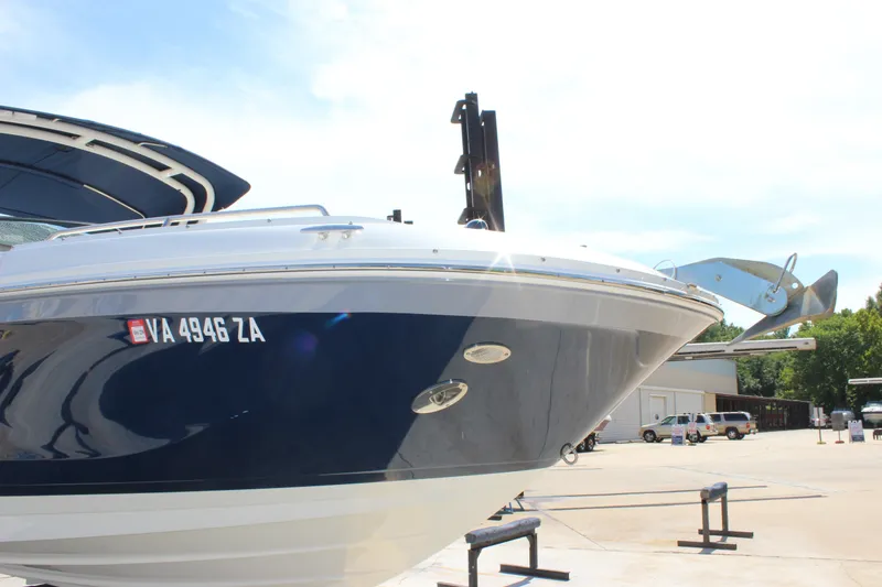 Slide: The Image of 2019 Sea Ray SDX 290 boat docked, showcasing sleek design and registration number. - 26