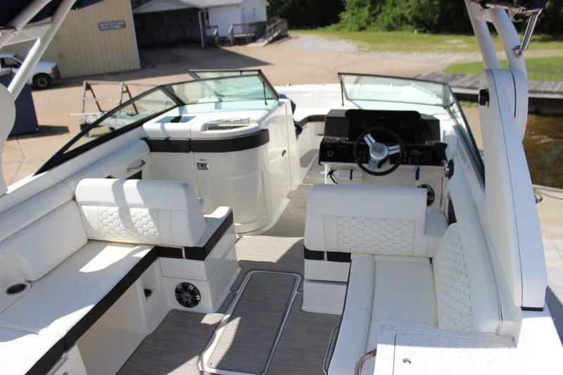 Slide: The Image of 2019 Sea Ray SDX 290 boat interior with luxurious seating and modern dashboard. - 37