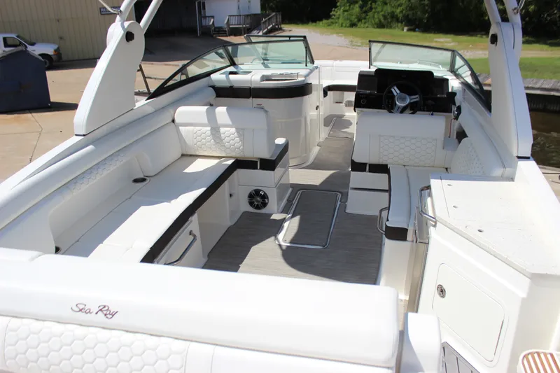 Slide: The Image of 2019 Sea Ray SDX 290 boat interior with white seating and modern dashboard. - 31