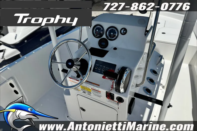 Slide: The Image of 2027 Bayliner Trophy T18 boat dashboard with steering wheel and controls. - 16
