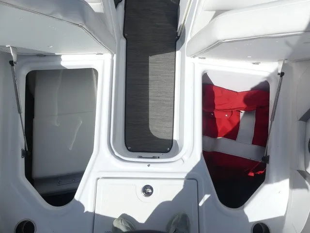 Slide: The Image of The image shows the interior of a 2021 Four Winns HD3 Surf boat with storage compartments. - 20