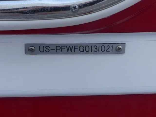 Slide: The Image of Close-up of a serial number on a red boat hull. - 32