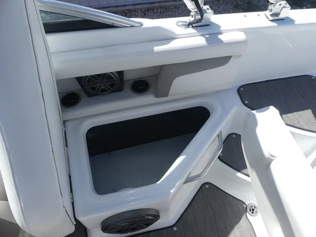 Slide: The Image of The image shows the interior of a 2021 Four Winns HD3 Surf boat with storage and speakers. - 24