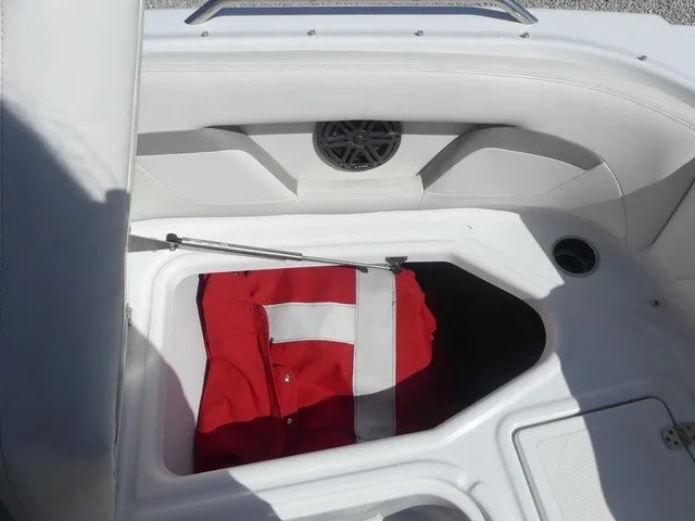Slide: The Image of A storage compartment in a boat with a red life jacket inside. - 22