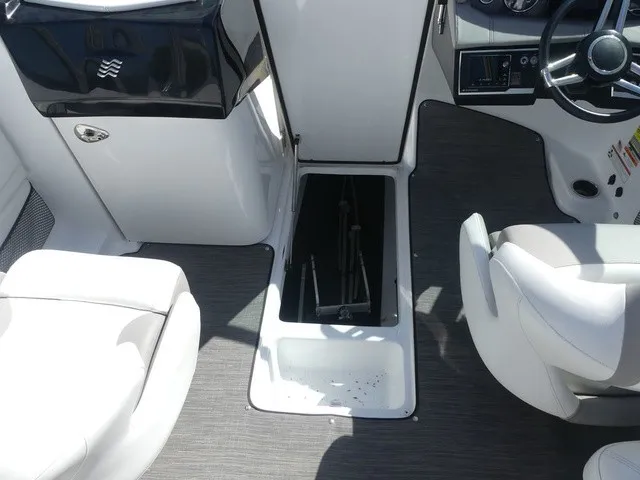 Slide: The Image of Interior view of a 2021 Four Winns HD3 Surf with white seating and storage compartment. - 27