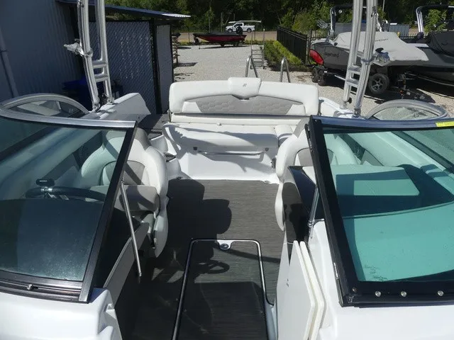 Slide: The Image of The image shows the cockpit of a 2021 Four Winns HD3 Surf boat with white seating. - 23