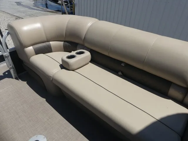 Slide: The Image of The image shows a beige upholstered bench seat on a boat with cup holders. - 35