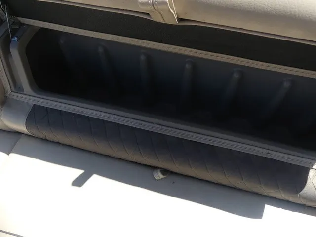 Slide: The Image of An open storage compartment on a boat with cushioned seating and a sturdy design. - 37