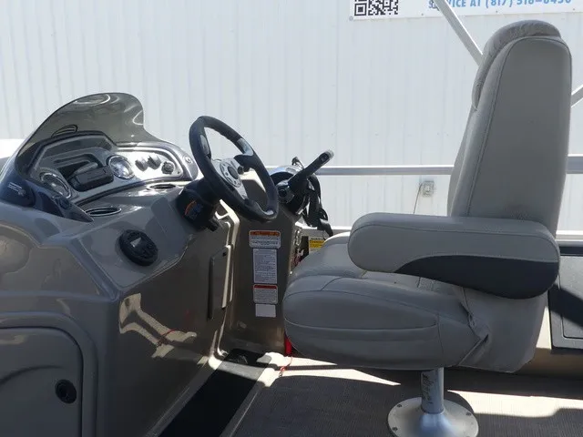 Slide: The Image of The image shows the helm of a 2020 Sun Tracker SportFish 22 DLX with a comfortable captain's chair. - 15