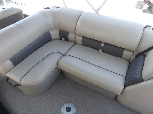 Slide: The Image of The 2020 Sun Tracker SportFish 22 DLX features comfortable beige seating with cup holders. - 24