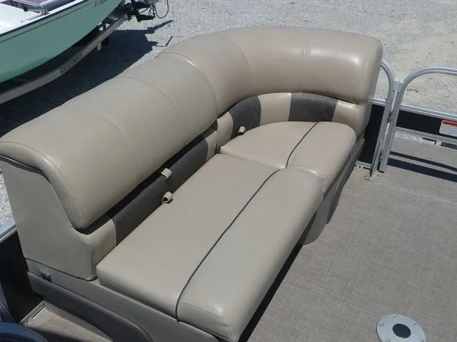Slide: The Image of The image shows a beige upholstered bench seat on a boat, surrounded by gray flooring. - 22