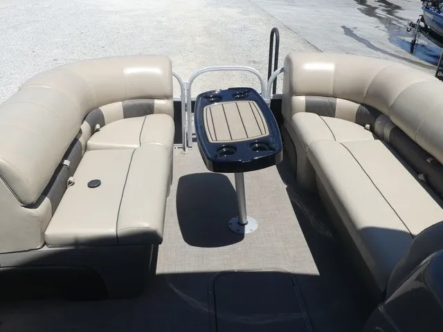 Slide: The Image of Interior view of a 2020 Sun Tracker SportFish 22 DLX with beige seating and a table. - 38