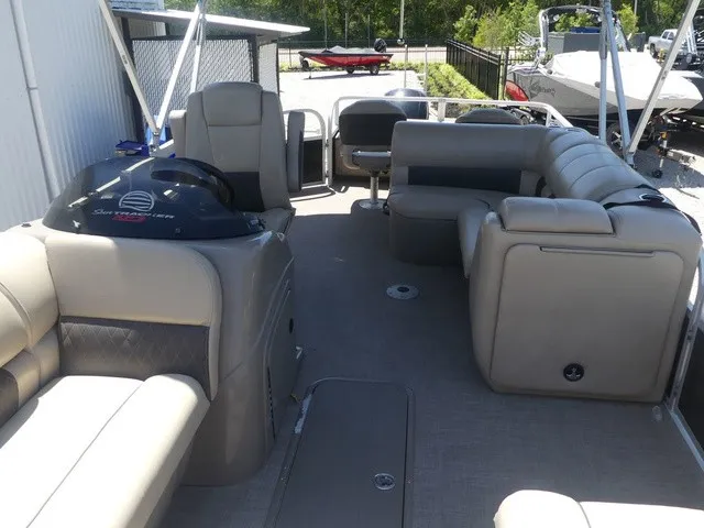 Slide: The Image of The image shows the spacious deck of a 2020 Sun Tracker SportFish 22 DLX with comfortable seating. - 20