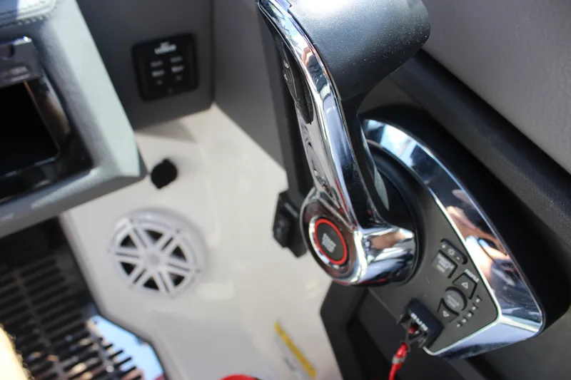 Slide: The Image of Close-up of 2024 Cobalt R6 Outboard boat throttle control and speaker. - 28