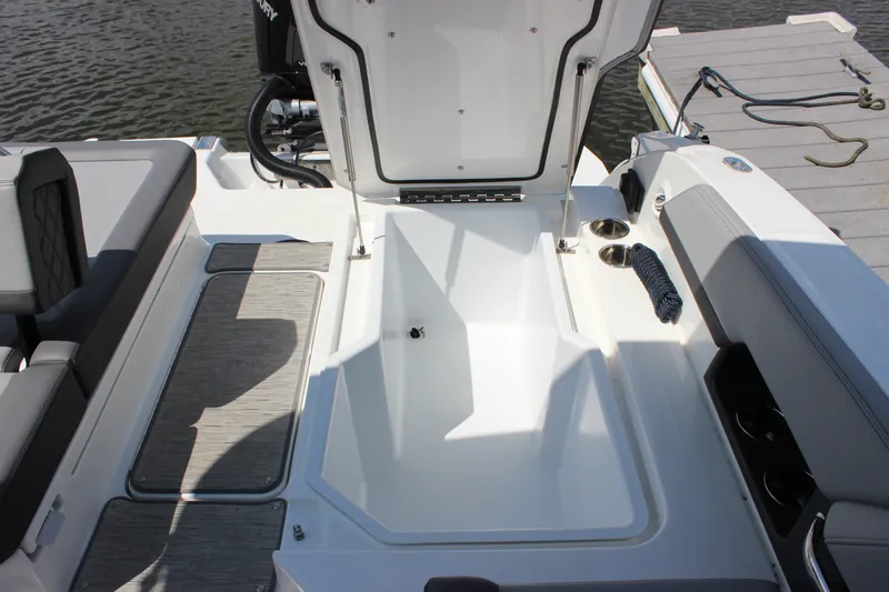 Slide: The Image of 2024 Cobalt R6 Outboard boat interior with open storage compartment and seating. - 33