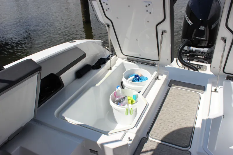 Slide: The Image of 2024 Cobalt R6 Outboard boat with open storage compartments and cleaning supplies. - 37