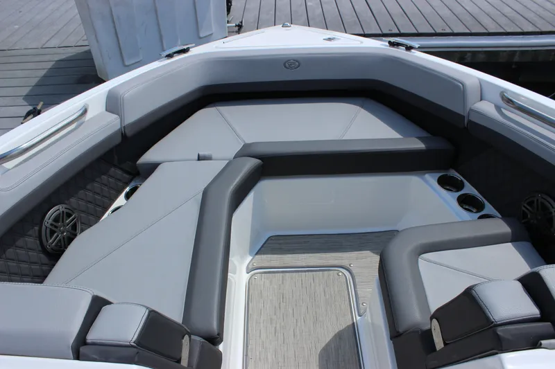 Slide: The Image of 2024 Cobalt R6 Outboard boat interior with gray seating and cup holders. - 16