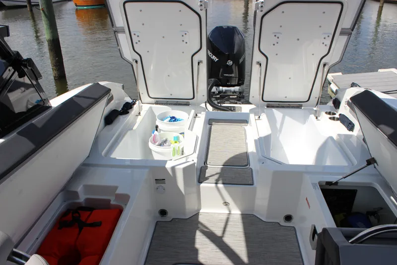 Slide: The Image of 2024 Cobalt R6 Outboard boat interior with storage compartments and Mercury engine. - 39