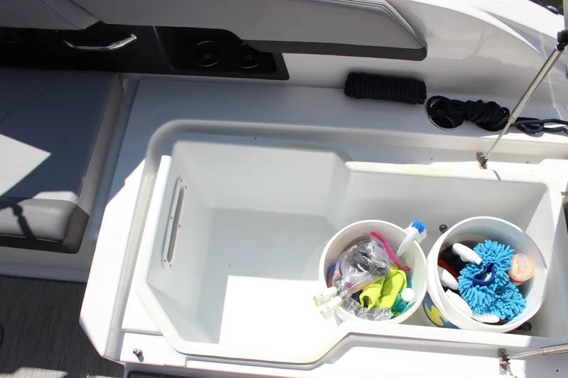 Slide: The Image of 2024 Cobalt R6 Outboard boat storage compartment with cleaning supplies and accessories. - 32