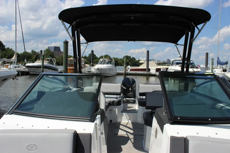 Slide: The Image of 2024 Cobalt R6 Outboard boat docked at a marina under a clear sky. - 19