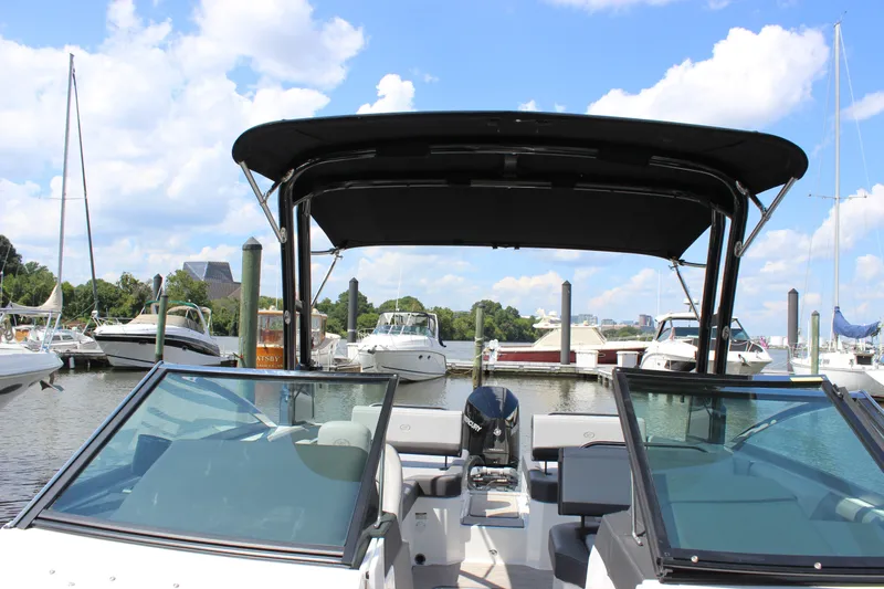 Slide: The Image of 2024 Cobalt R6 Outboard boat docked at marina under clear blue sky. - 20