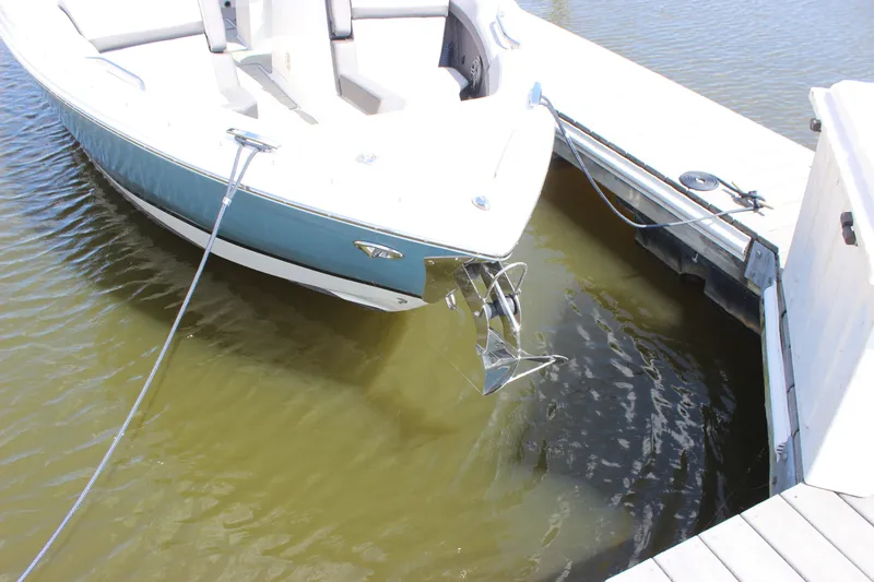 Slide: The Image of 2024 Cobalt R6 Outboard boat docked on calm water, showcasing sleek design. - 6