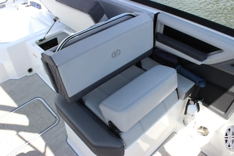 Slide: The Image of 2024 Cobalt R6 Outboard boat interior with gray seating and safety equipment. - 34