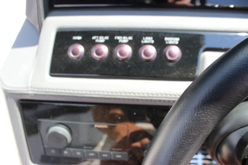 Slide: The Image of Dashboard controls of a 2024 Cobalt R6 Outboard boat with steering wheel. - 29