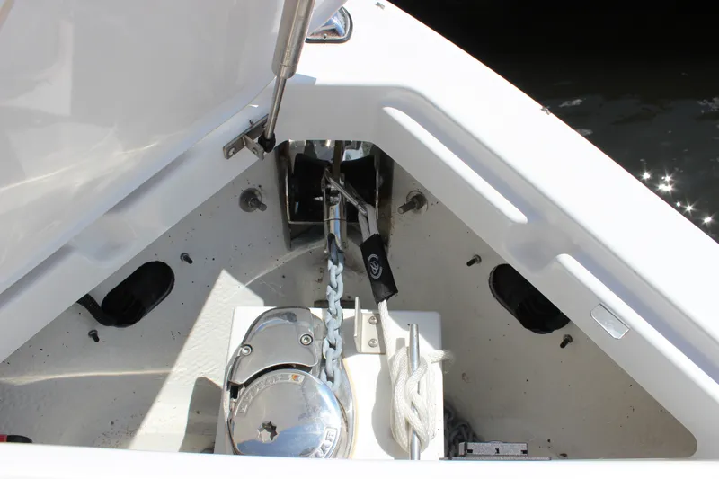 Slide: The Image of Anchor compartment of 2024 Cobalt R6 Outboard boat with chain and rope. - 22