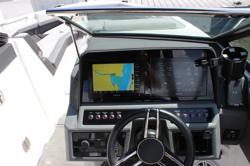 Slide: The Image of 2024 Cobalt R6 Outboard dashboard with dual Garmin displays and modern controls. - 43