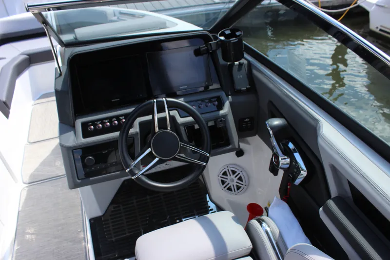 Slide: The Image of 2024 Cobalt R6 Outboard boat cockpit with modern steering and controls. - 15