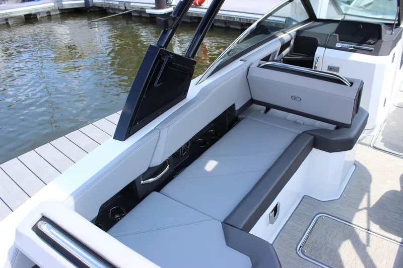 Slide: The Image of 2024 Cobalt R6 Outboard boat interior with sleek seating by the dock. - 13
