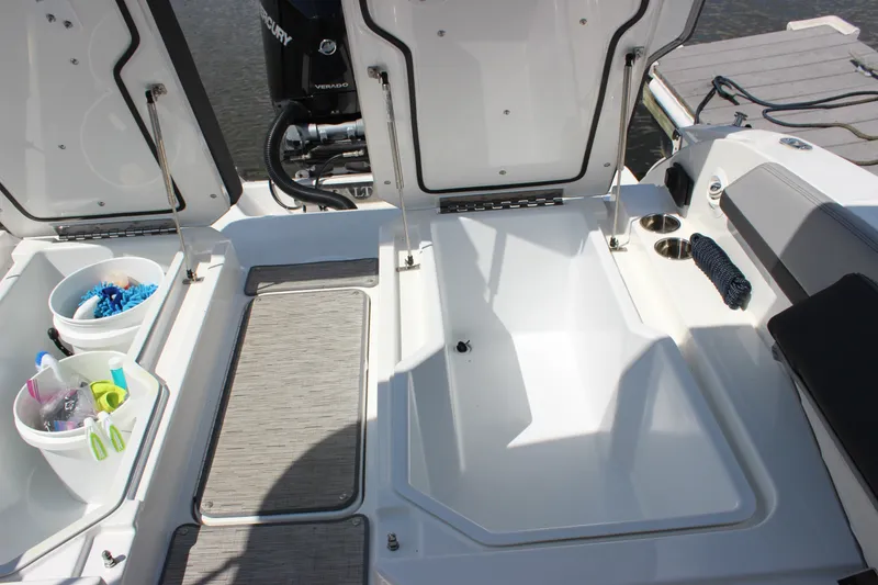 Slide: The Image of 2024 Cobalt R6 Outboard boat storage compartments with cleaning supplies and accessories. - 36