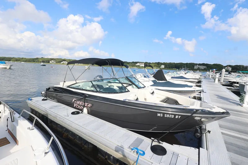 Slide: The Image of 2014 Monterey 268SS Super Sport boat docked at a marina under a clear blue sky. - 3