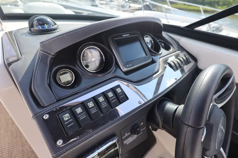 Slide: The Image of Dashboard of a 2014 Monterey 268SS Super Sport boat with steering wheel and controls. - 23