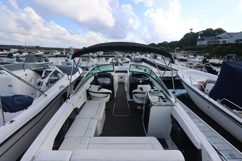 Slide: The Image of 2014 Monterey 268SS Super Sport boat docked at a marina under a cloudy sky. - 6
