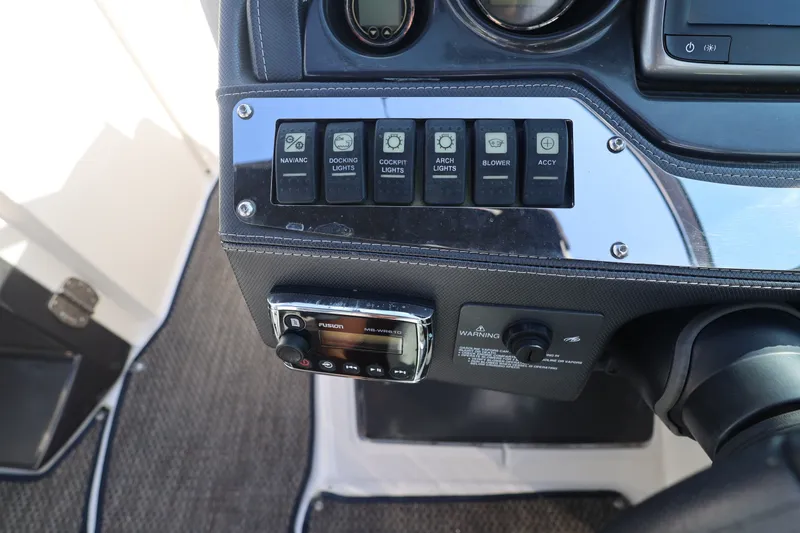 Slide: The Image of Control panel of a 2014 Monterey 268SS Super Sport boat with switches and radio. - 24