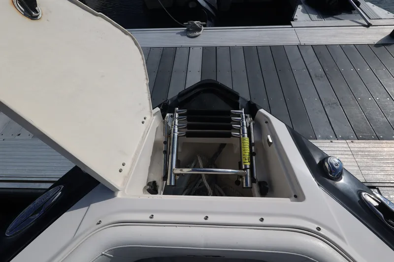 Slide: The Image of An open storage compartment on a boat with a retractable ladder and an anchor. - 36