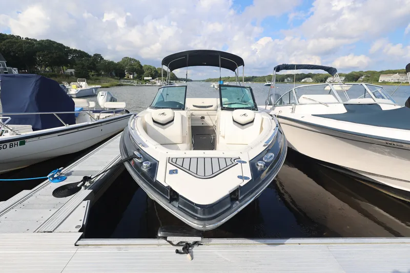 Slide: The Image of 2014 Monterey 268SS Super Sport boat docked at a marina under a partly cloudy sky. - 1